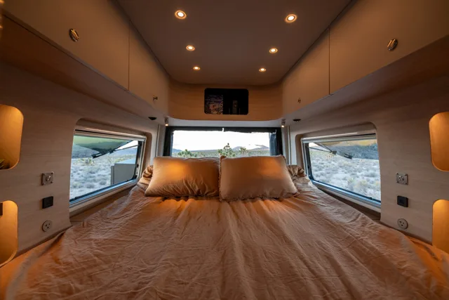 Noovo Next rear queen bed with pillows between the two rear windows