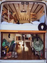 Bed setup inside Ford Transit camper van rental in GLENDALE California