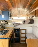 Bed setup inside Adventure Wagon The Farley camper van rental in Bellevue Washington