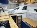 Bed setup inside Adventure Wagon The Farley camper van rental in Bellevue Washington