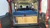 Bed setup inside Wayfarer Wally camper van rental in Bellevue Washington