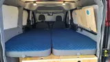 Bed setup inside Wayfarer Wally camper van rental in Bellevue Washington