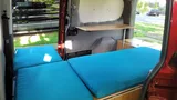 Bed setup inside Wayfarer Wally camper van rental in Bellevue Washington