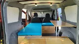 Bed setup inside Wayfarer Wally camper van rental in Bellevue Washington