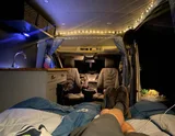 Bed setup inside Ford Transit camper van rental in Bellevue Washington