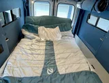 Bed setup inside Ford Transit camper van rental in Bellevue Washington