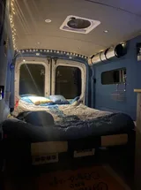 Bed setup inside Ford Transit camper van rental in Bellevue Washington