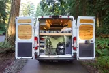 Bed setup inside Dodge Alpenglow camper van rental in Bellevue Washington