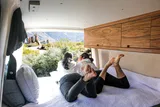 Bed setup inside Mercedes-Benz Yardman2 camper van rental in Eastvale California