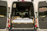 Bed setup inside Mercedes-Benz Astro Camper camper van rental in Eastvale California