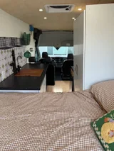 Bed setup inside Ford Transit camper van rental in Lakewood California