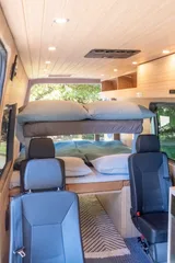 Bed setup inside Forged Vans Sprinter camper van rental in Bellevue Washington