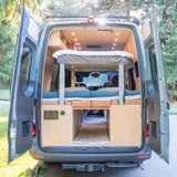 Bed setup inside Forged Vans Sprinter camper van rental in Bellevue Washington
