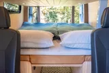 Bed setup inside Forged Vans Sprinter camper van rental in Bellevue Washington