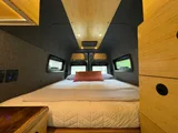 Bed setup inside VT Adventures joy Ride camper van rental in Burlington Vermont
