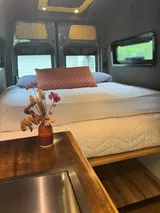 Bed setup inside VT Adventures joy Ride camper van rental in Burlington Vermont