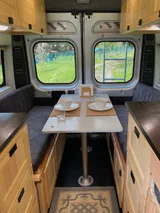 Bed setup inside RAM Mu camper van rental in Bellevue Washington