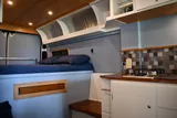 Bed setup inside RAM River Run camper van rental in Spokane Washington