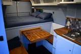 Bed setup inside RAM River Run camper van rental in Spokane Washington