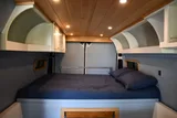Bed setup inside RAM River Run camper van rental in Spokane Washington