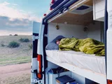 Bed setup inside Dodge Squatchy camper van rental in Durango Colorado
