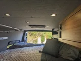 Bed setup inside Navan Vans Guinevere camper van rental in Bellevue Washington