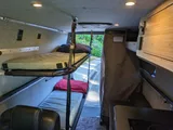 Bed setup inside Navan Vans Guinevere camper van rental in Bellevue Washington