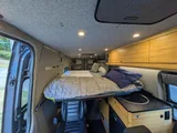Bed setup inside Navan Vans Guinevere camper van rental in Bellevue Washington