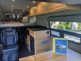 Bed setup inside Navan Vans Guinevere camper van rental in Bellevue Washington