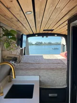 Bed setup inside Ford Transit camper van rental in GLENDALE California