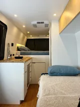 Bed setup inside Wheel Suites Grand Suite camper van rental in Hackensack New Jersey
