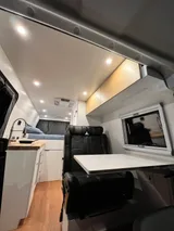 Bed setup inside Wheel Suites Grand Suite camper van rental in Hackensack New Jersey