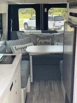 Bed setup inside Pleasure Way Ontour 2.2 camper van rental in Orlando Florida